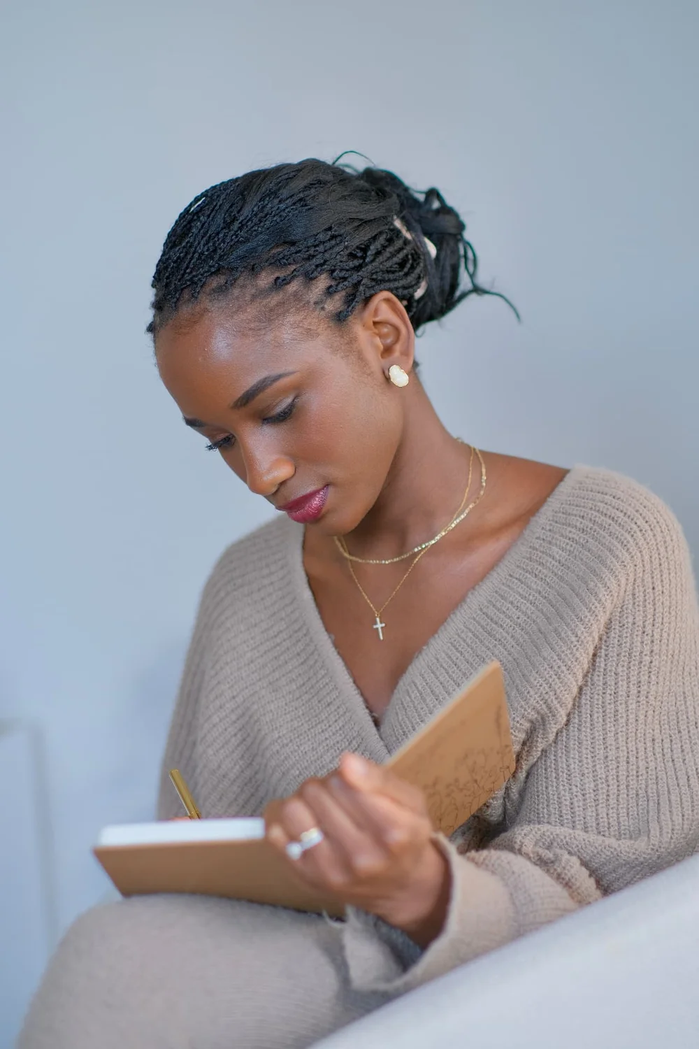 Elizabeth Zion writing in a gratitude journal