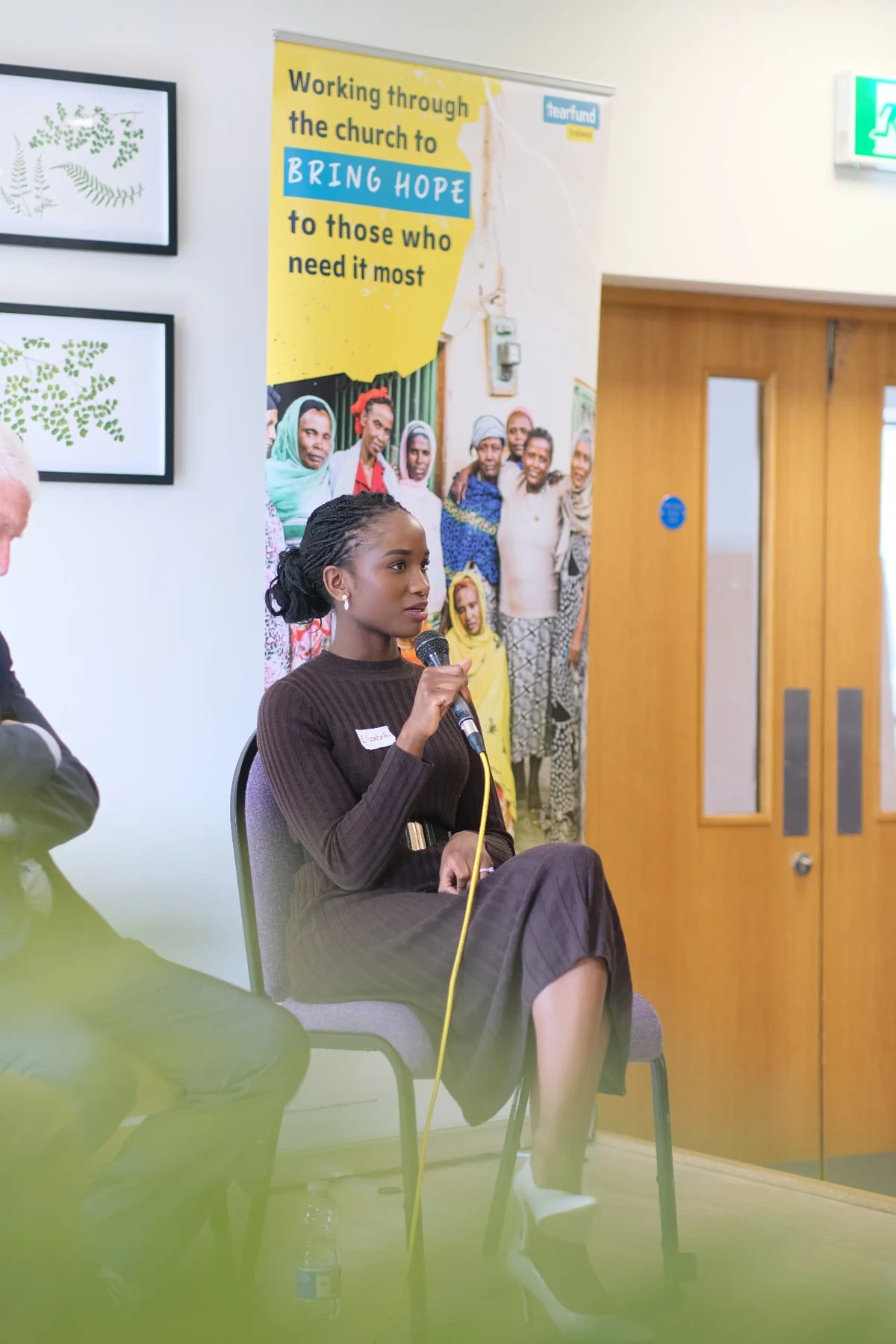 Elizabeth Zion facilitating a conversation in a colourful meeting room