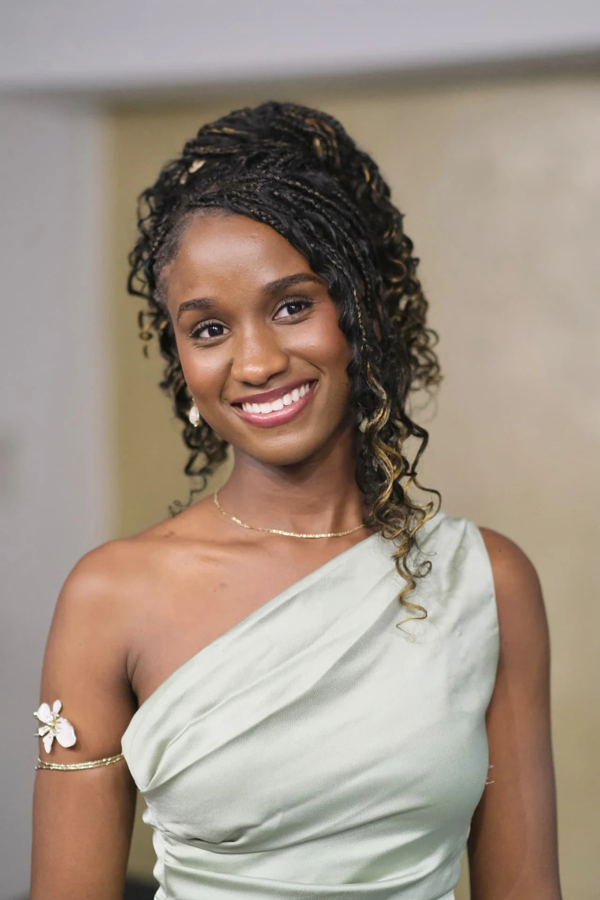 Elizabeth Zion smiling in a pale mint dress indoors