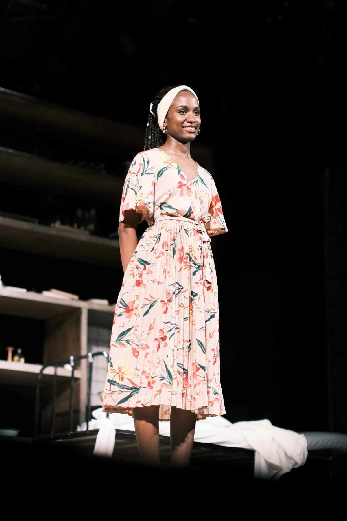 Elizabeth Zion speaking on stage in a floral dress