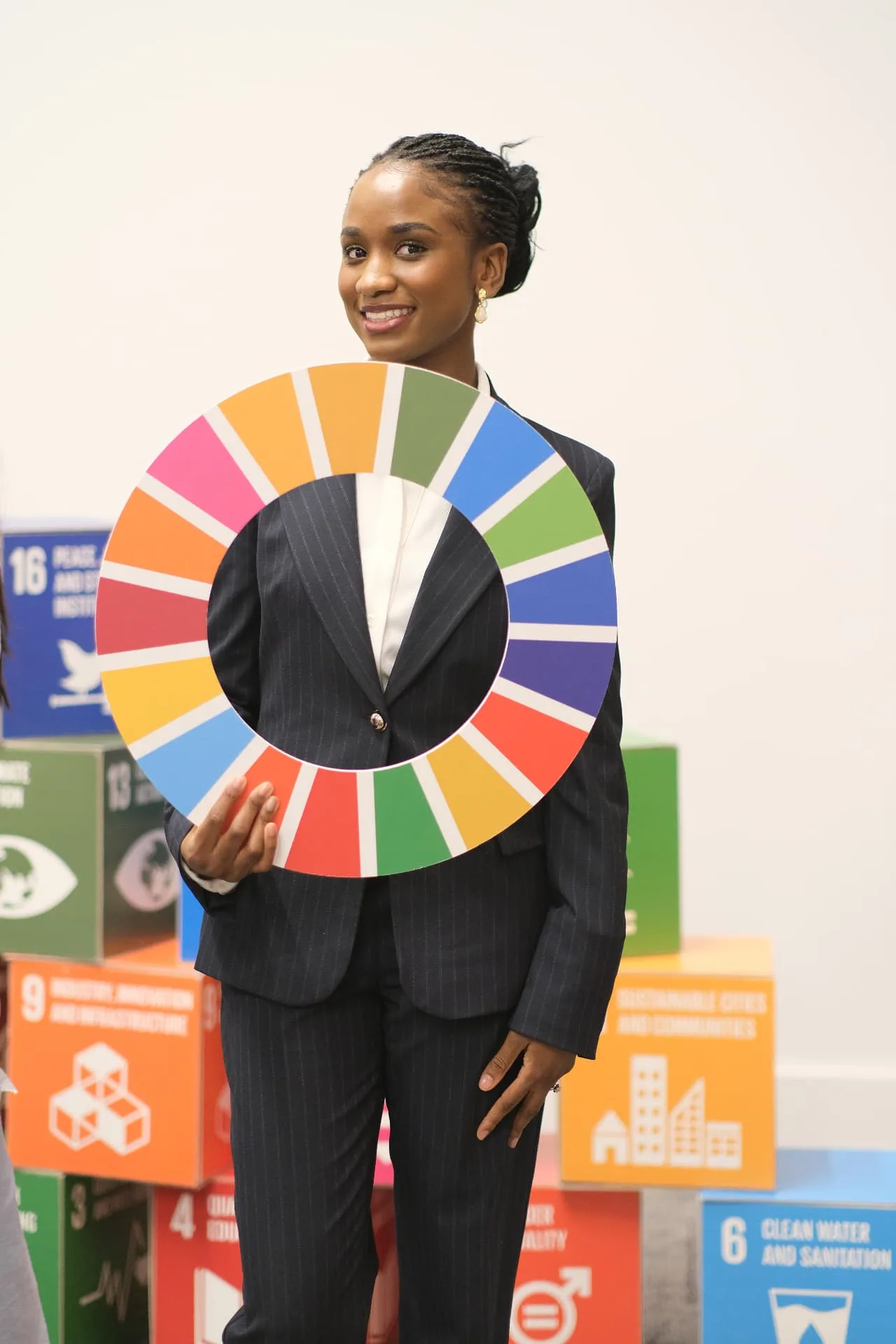 Elizabeth Zion holding the SDG wheel at a sustainability event