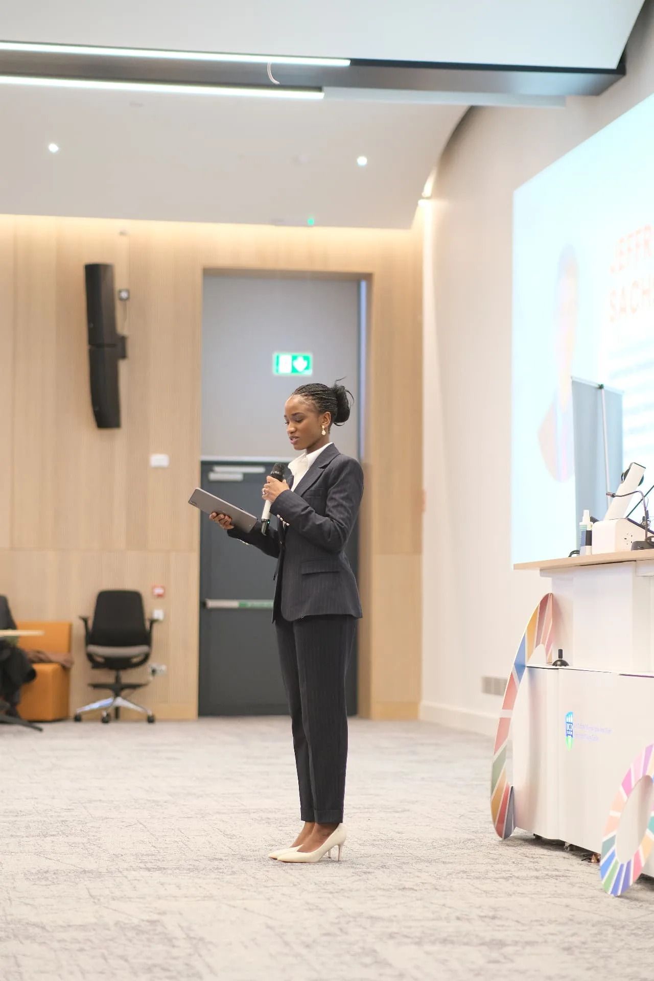 Elizabeth Zion presenting in a bright seminar room